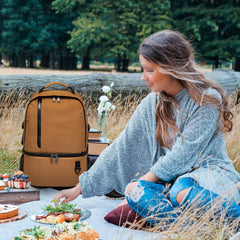 TUGUAN dual-compartment cooler opened, showing organized cold and room-temperature storage.