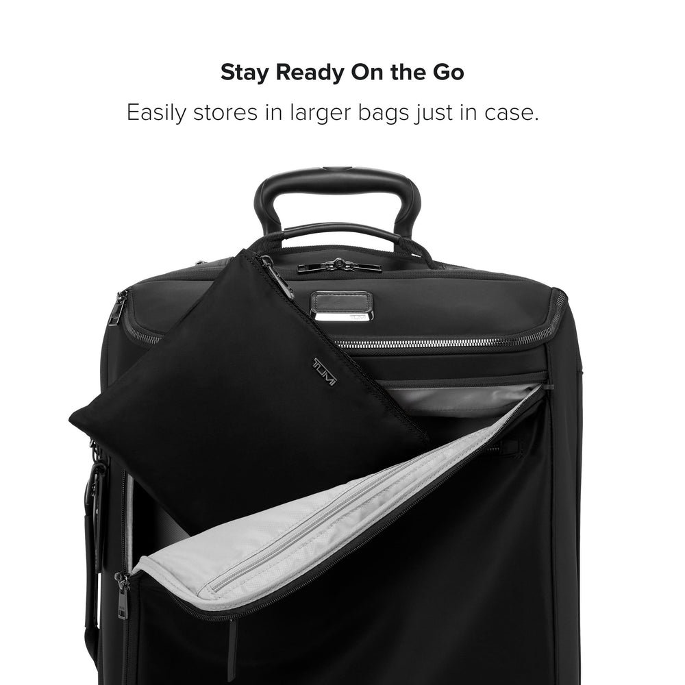 TUMI Just In Case Foldable Backpack carried by hand shows portable everyday carry.