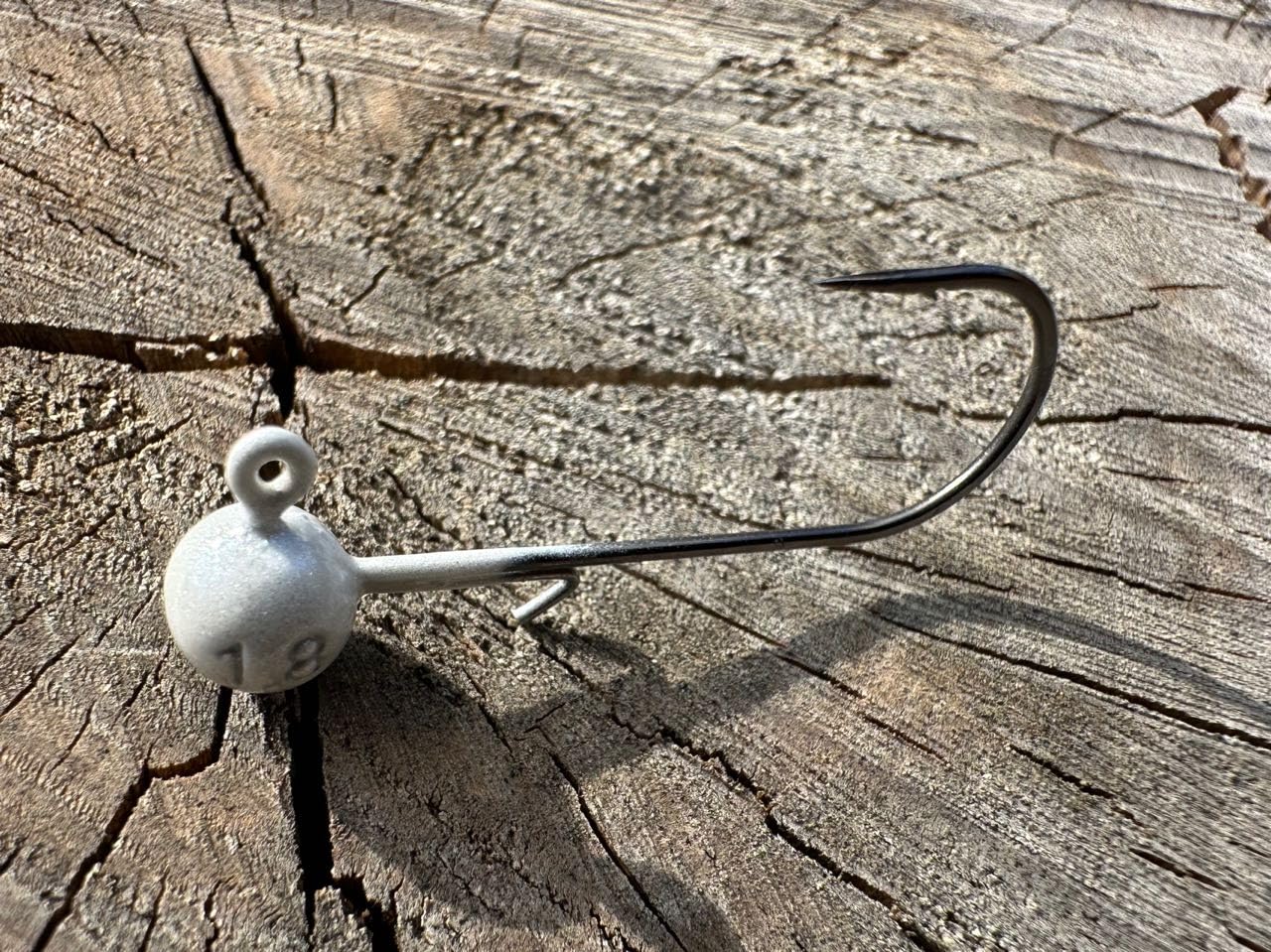 Close-up of 1/16 oz jig head showing tungsten ball and #2 hooks