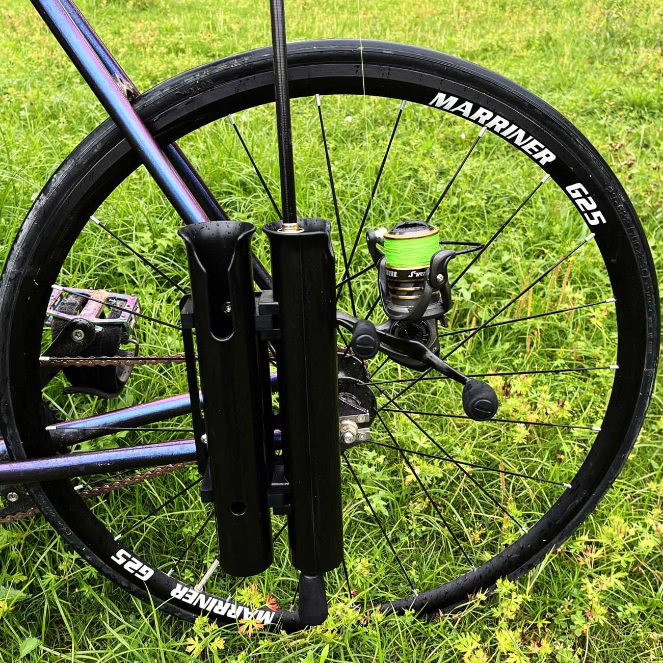 Close-up of two fishing rods secured in the bicycle rod holder.