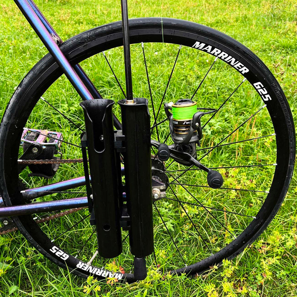 Close-up of two fishing rods secured in the bicycle rod holder.