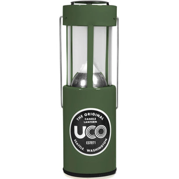 UCO 24352 candle lantern in use providing warm ambient light outdoors.