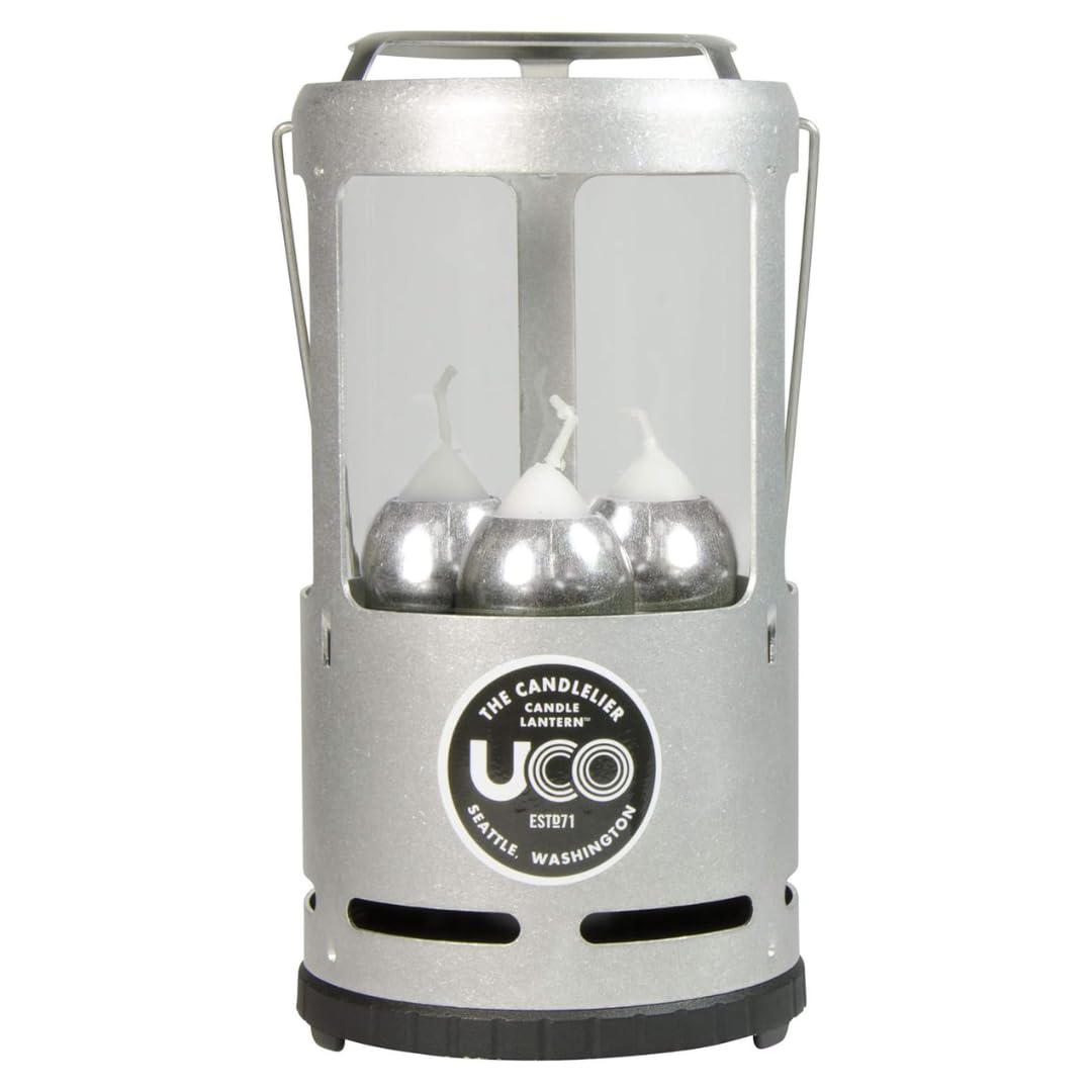 UCO Candlelier silver lantern glows warmly at campsite