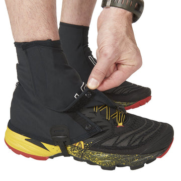 Ultimate Direction FK Gaiter black strap close-up highlighting Hypalon durability.