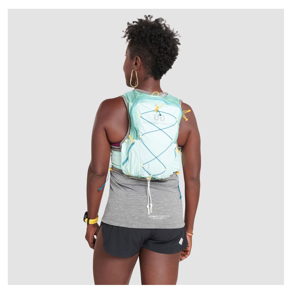 Ultimate Direction Womens Ultra Vesta 6.0 front bottle pockets support on-the-go hydration.
