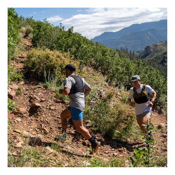 Trekking pole carry system shown on Xodus vest for easy gear stowing.