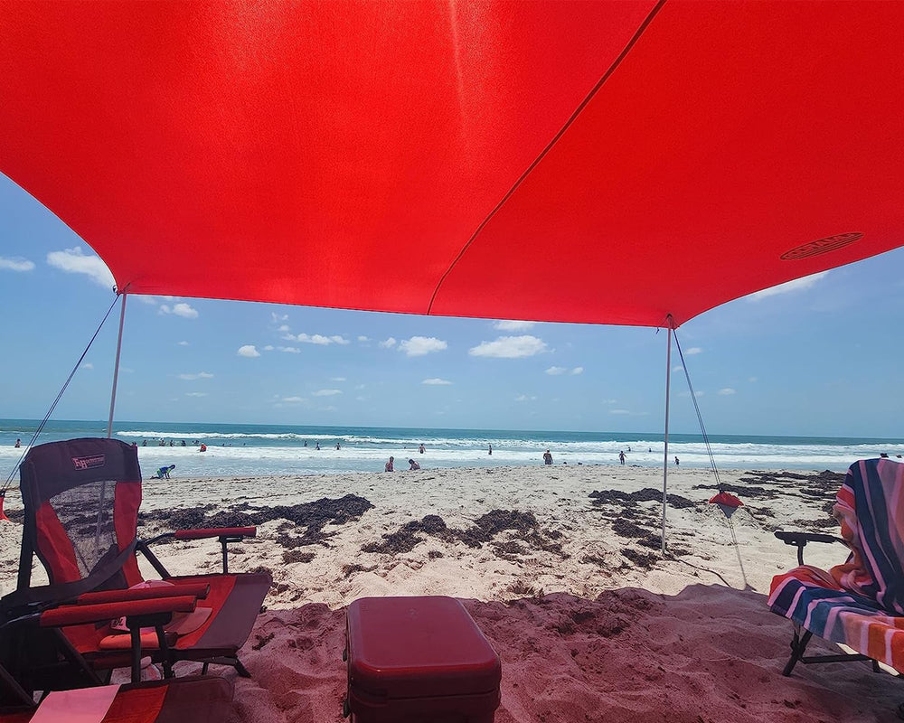 UMARDOO family using tent at seaside park for shade and relaxation