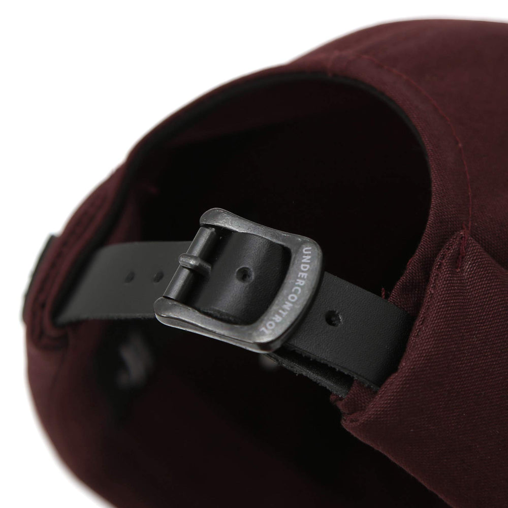 UNDERCONTROL VNTG brimless cap olive color on outdoor stroll for everyday adventures.