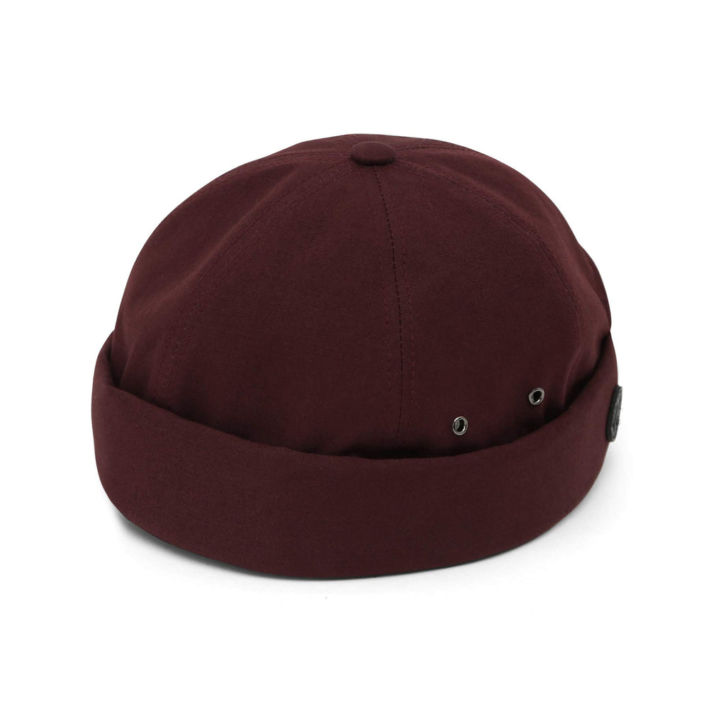 UNDERCONTROL VNTG brimless cap wine color rolled cuff lifestyle shot for outdoor indoors.