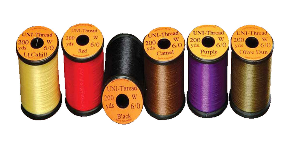 Uni Filter purple waxed thread on spool for smooth, durable fly tying wraps.