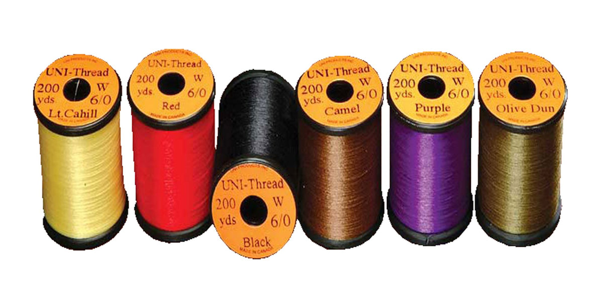 Uni Filter purple waxed thread on spool for smooth, durable fly tying wraps.