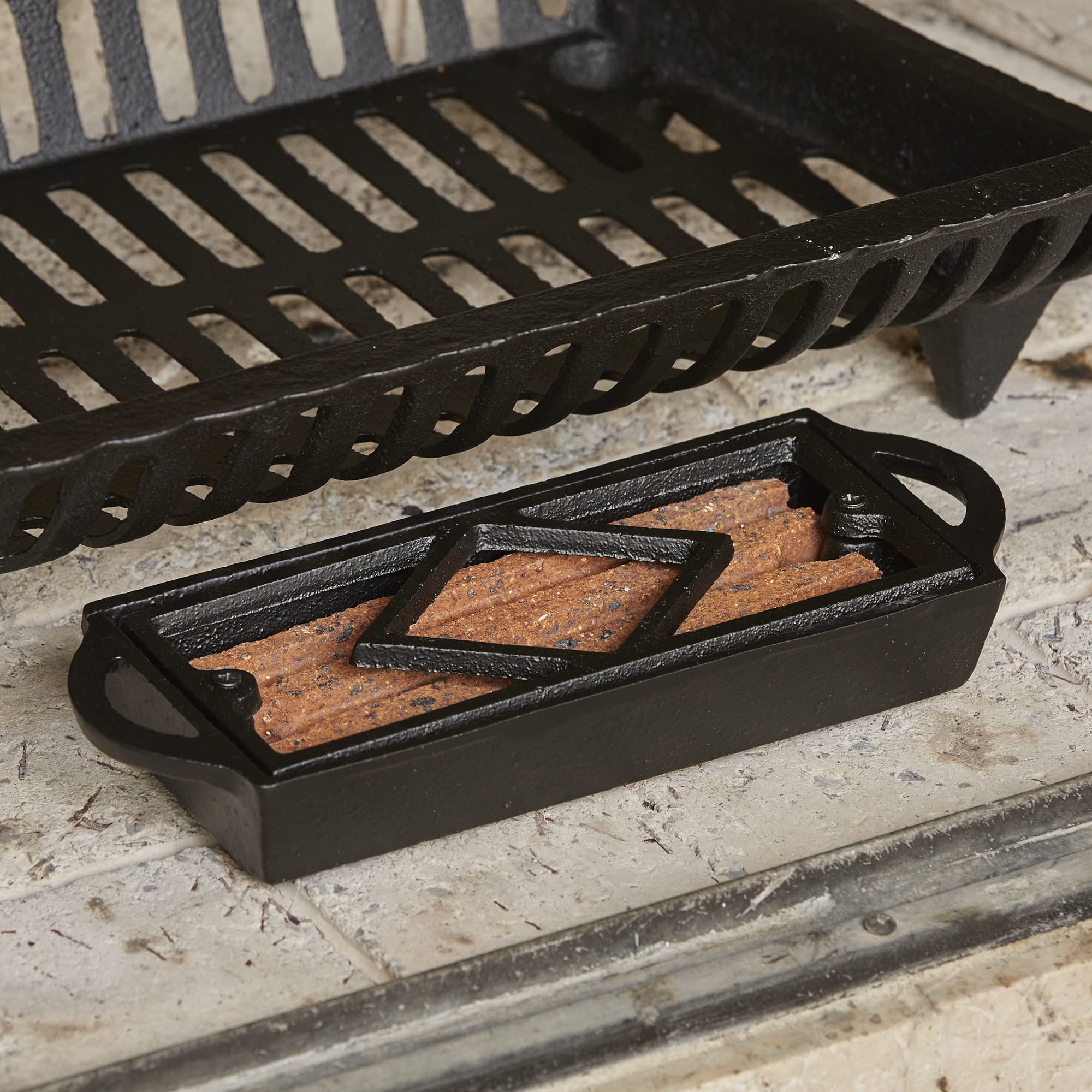 UniFlame Cast Iron Tray blends rugged look with practical fire-starting utility.