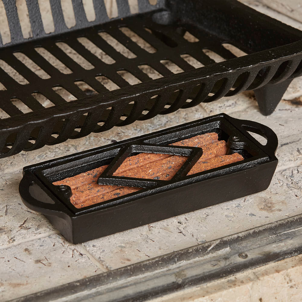 UniFlame Cast Iron Tray blends rugged look with practical fire-starting utility.