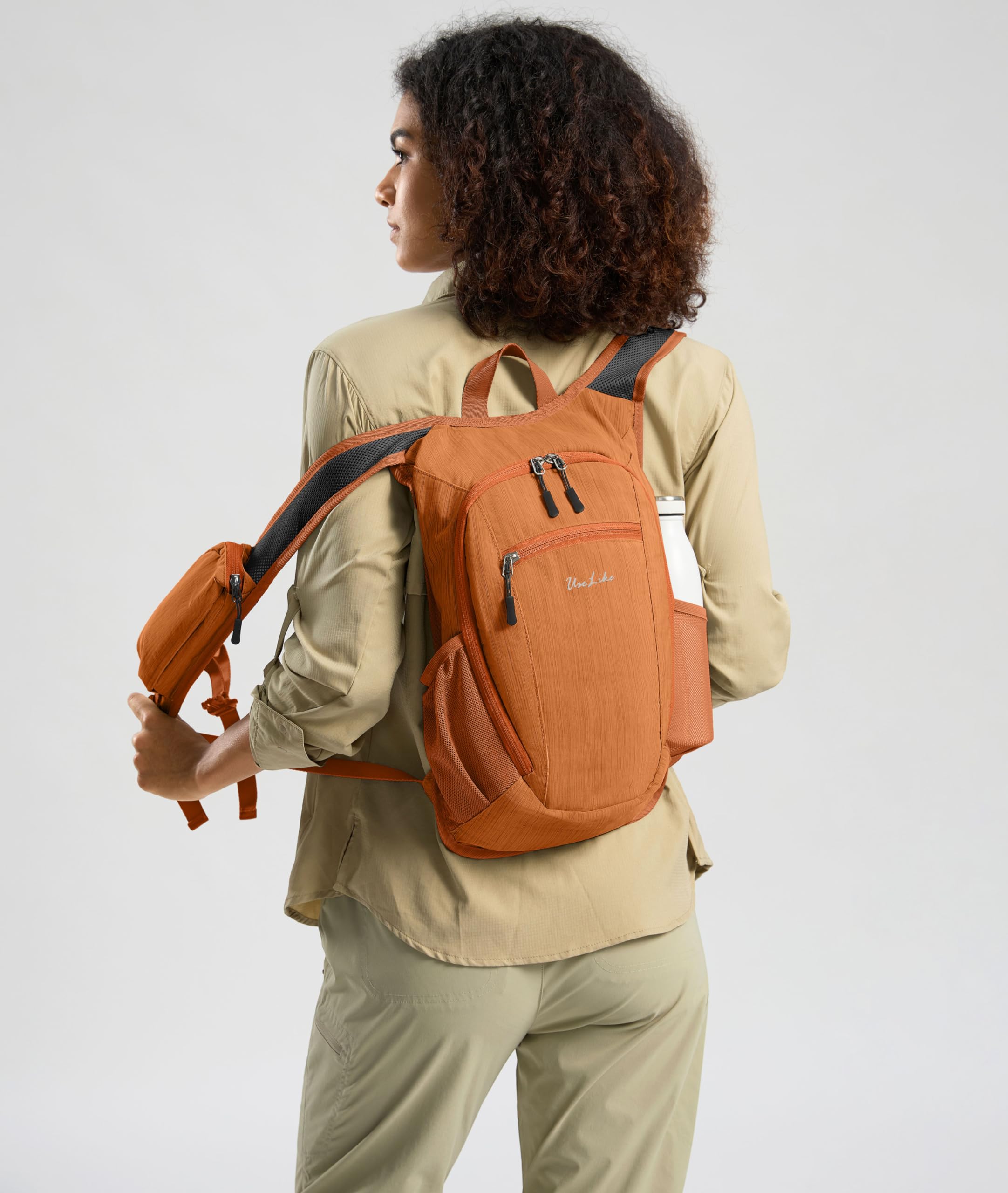Uselike 10L hiking backpack side pocket cell fits a phone up to 7 inches.