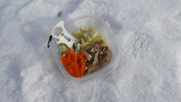 Outdoor dining scene with the ust Spork Multi-Tool in use.