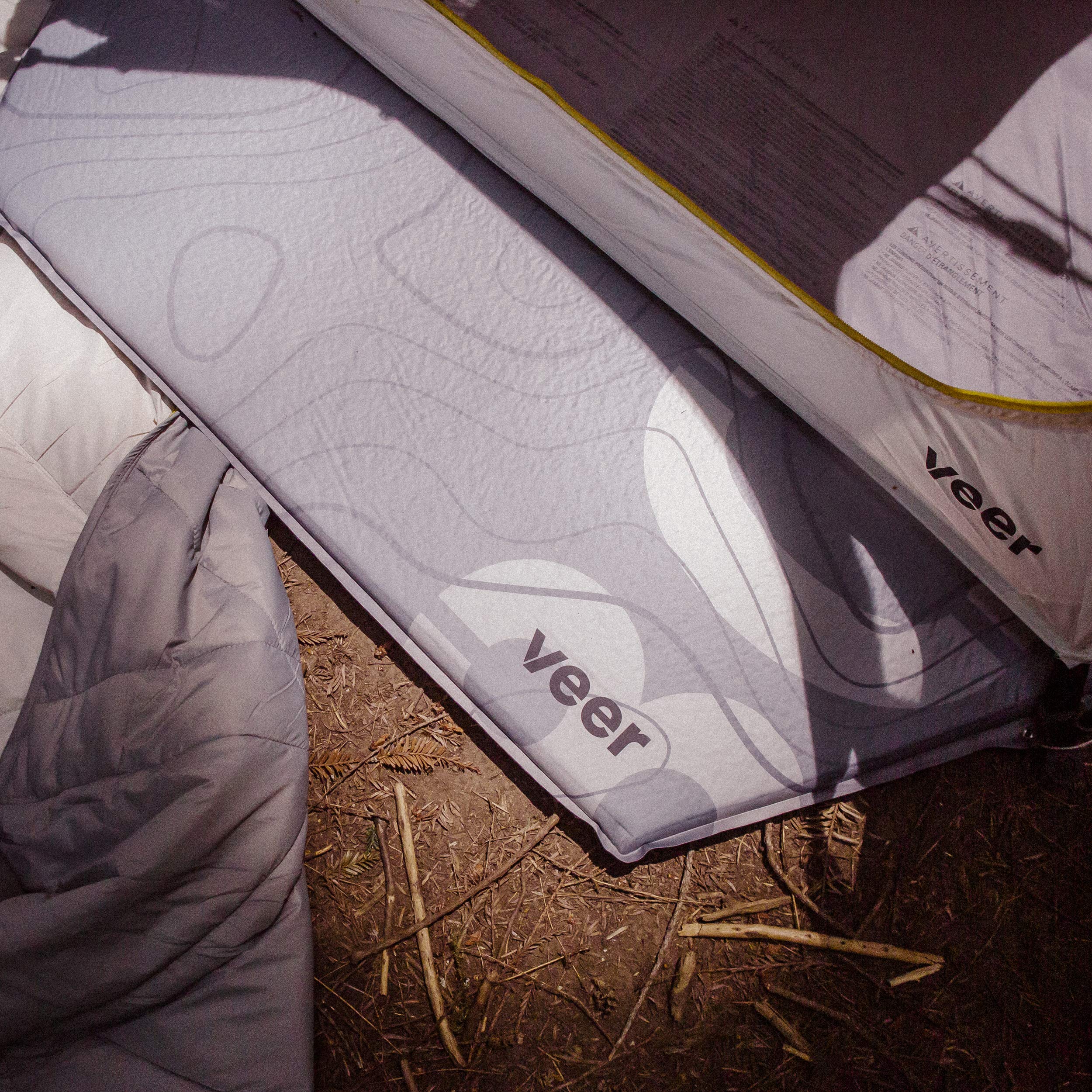 Veer Air Pad basecamp-ready setup on rugged ground.
