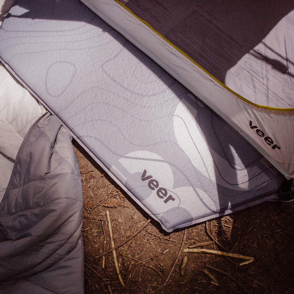 Veer Air Pad basecamp-ready setup on rugged ground.