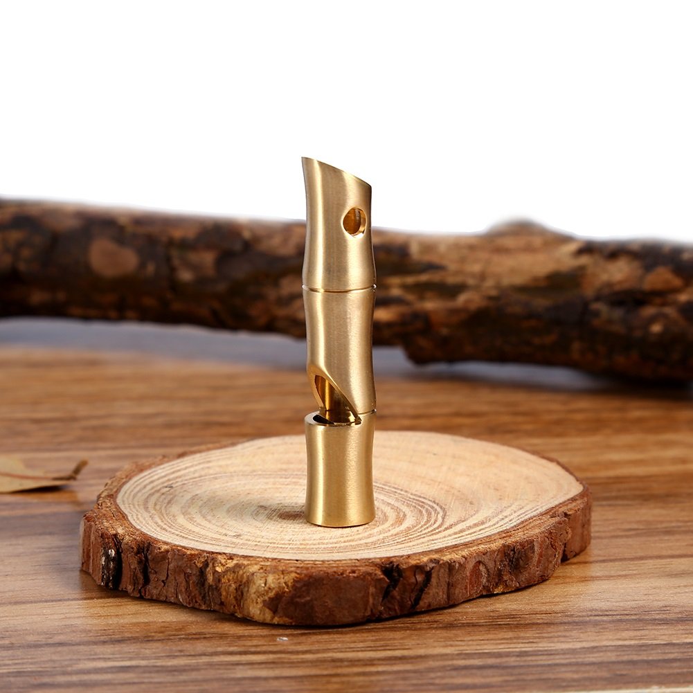 VGEBY brass whistle placed on camping gear for easy reach