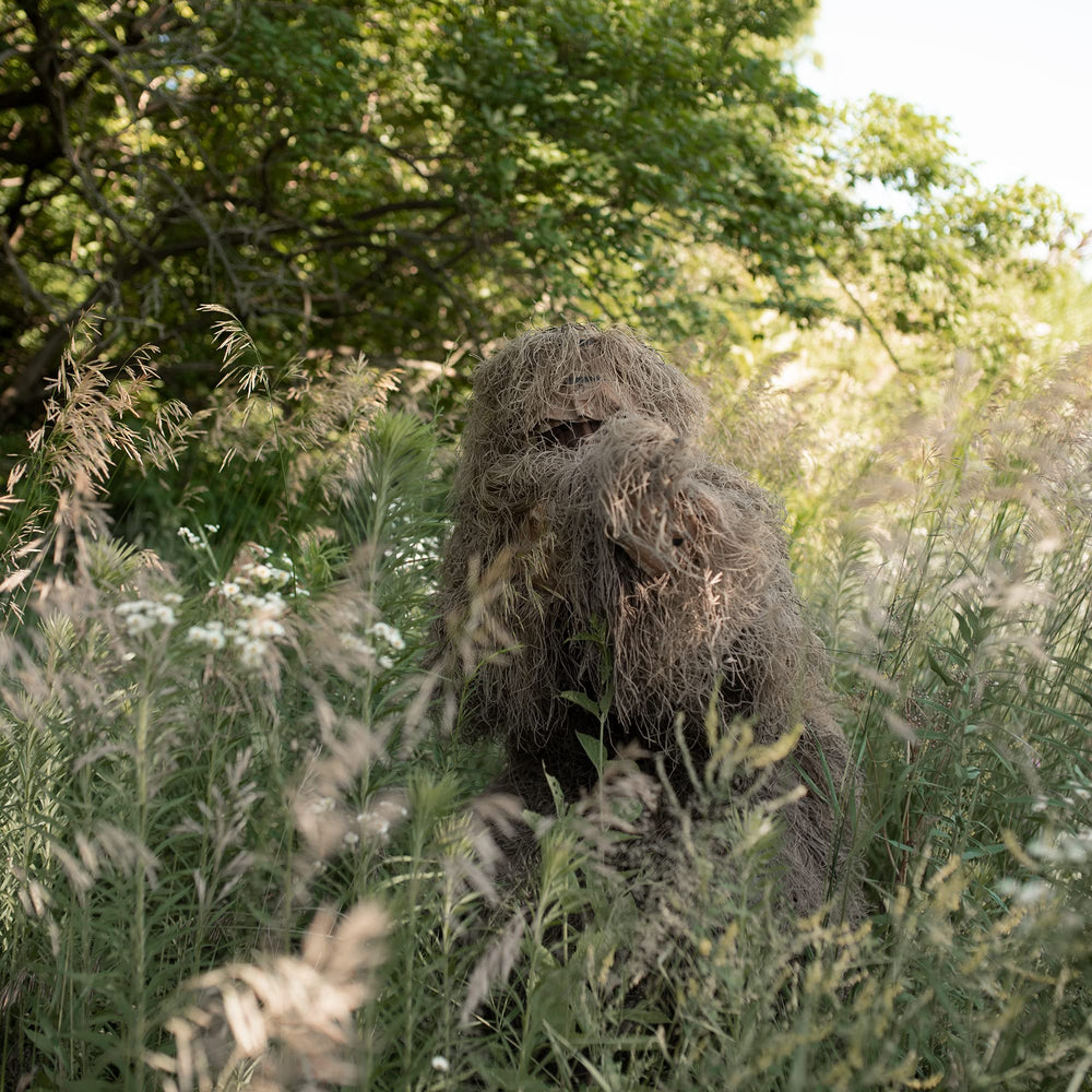 VIVO Ghillie Suit jacket blends with brush for discreet outdoor observation.