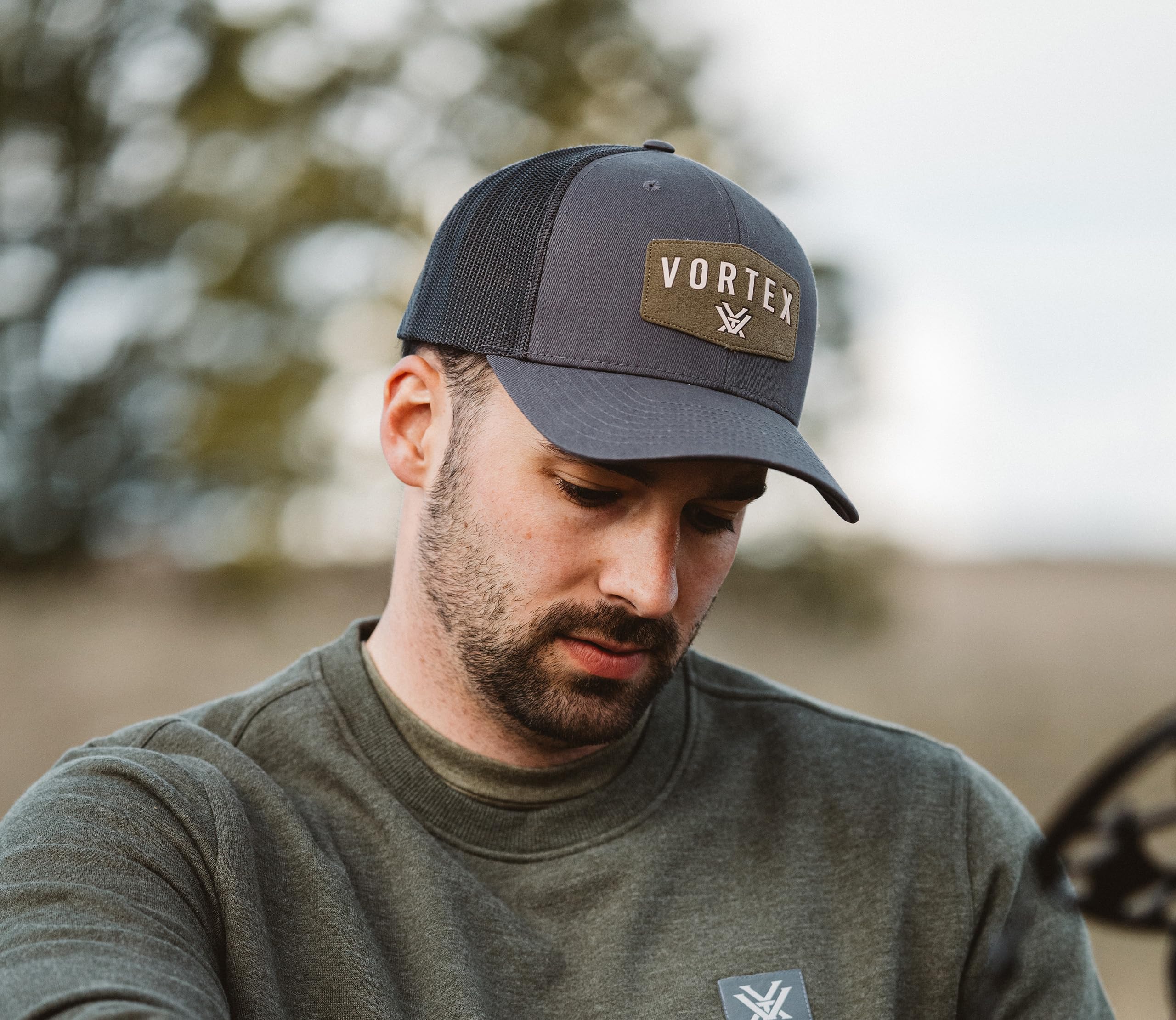 Interior tag showing material details of Vortex Optics Red Alert Cap Charcoal