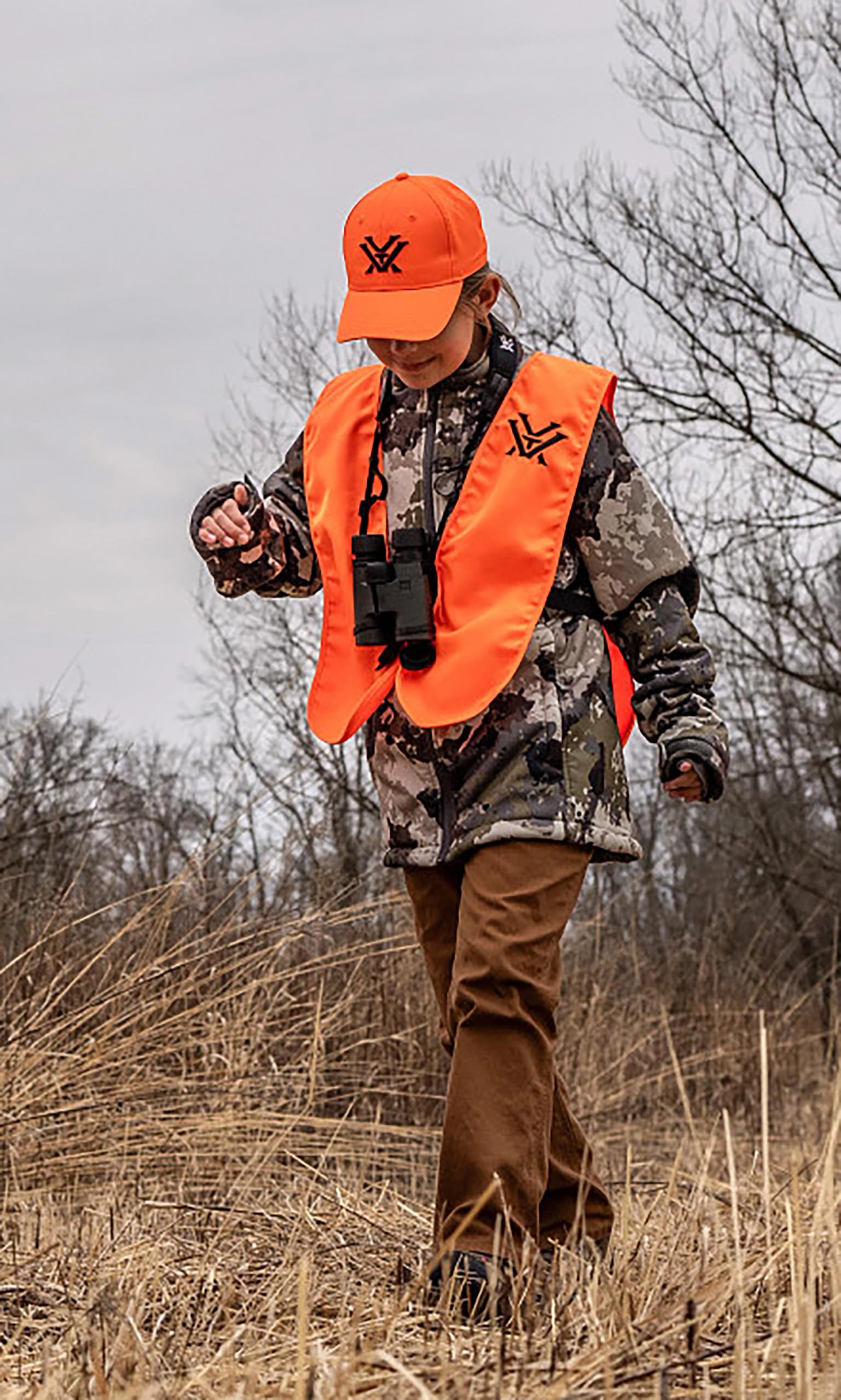Vortex Youth OSFM vest demonstrates adjustable fit over hunting gear.