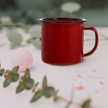 Camping scene with VOSAREA red enamel mug on a picnic table