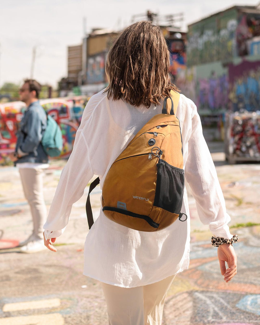 WATERFLY Sling Bag headphone hole enables easy listening on the move.