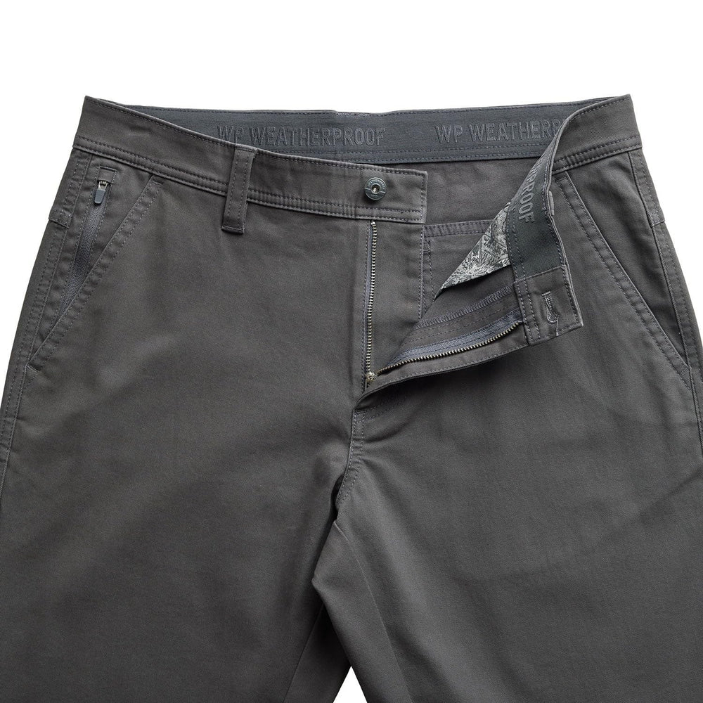 Weatherproof charcoal pants on model ideal for travel and everyday wear