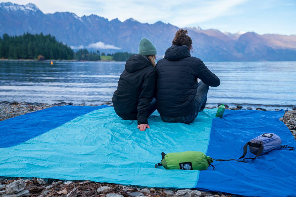 WEKAPO blanket used for camping and picnics in outdoor setting