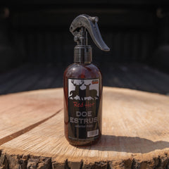 Close-up of Doe Estrous bottle showing clear liquid and label