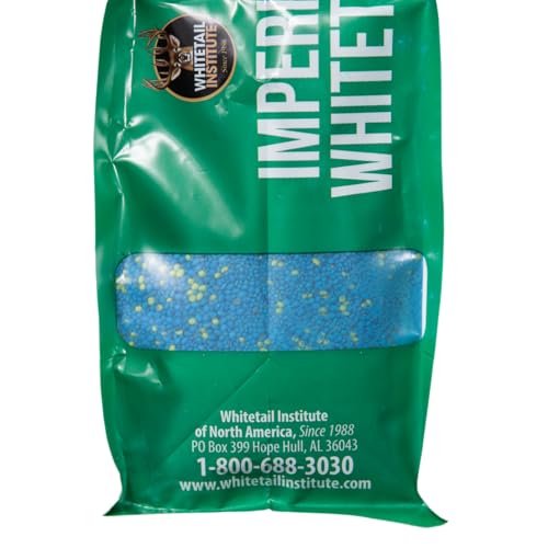 Imperial Clover seed pouring into a spreader for spring plot prep