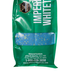 Imperial Clover seed pouring into a spreader for spring plot prep