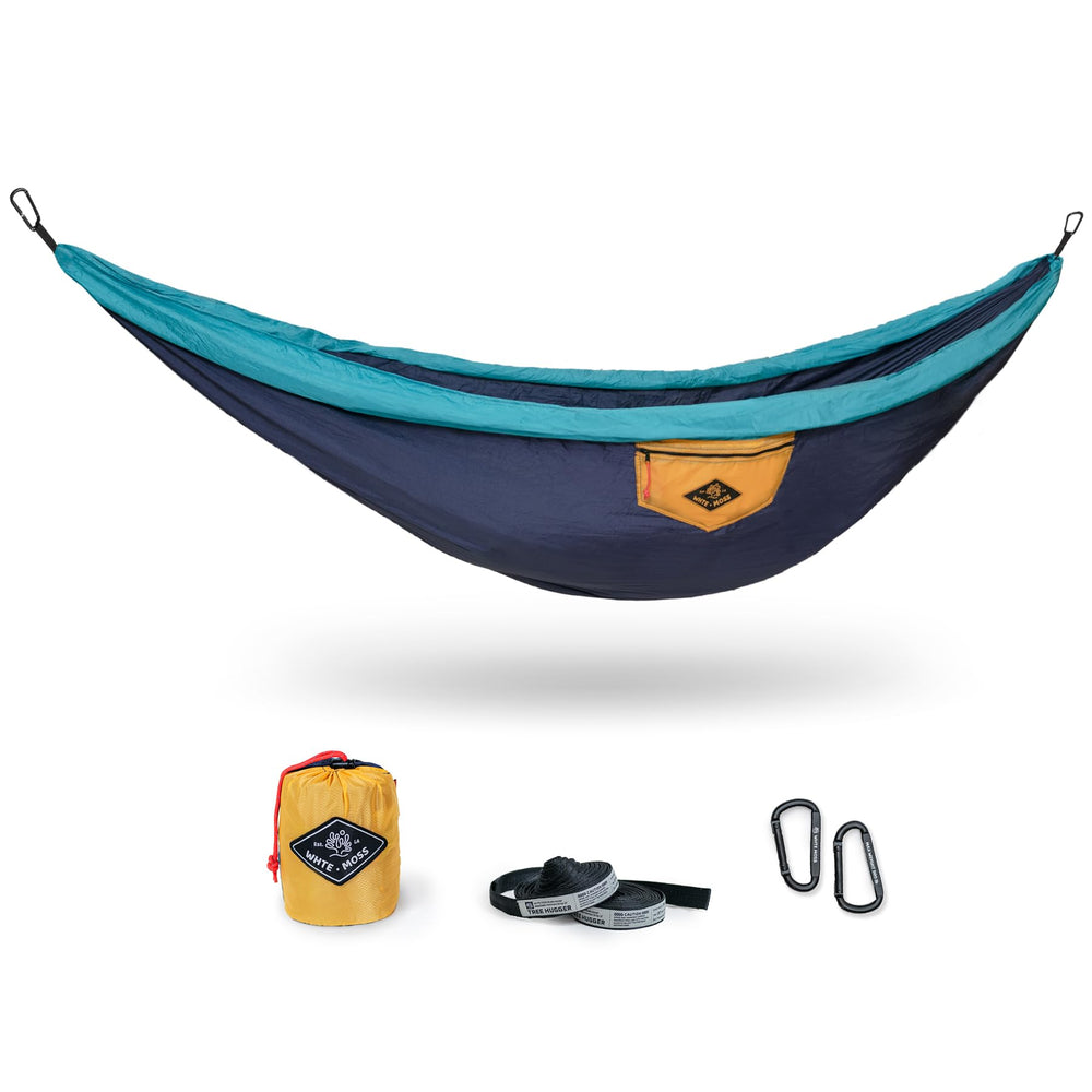 WHTE MOSS Suparpine II hammock setup in deep blue for easy outdoor lounging on a sunny campsite