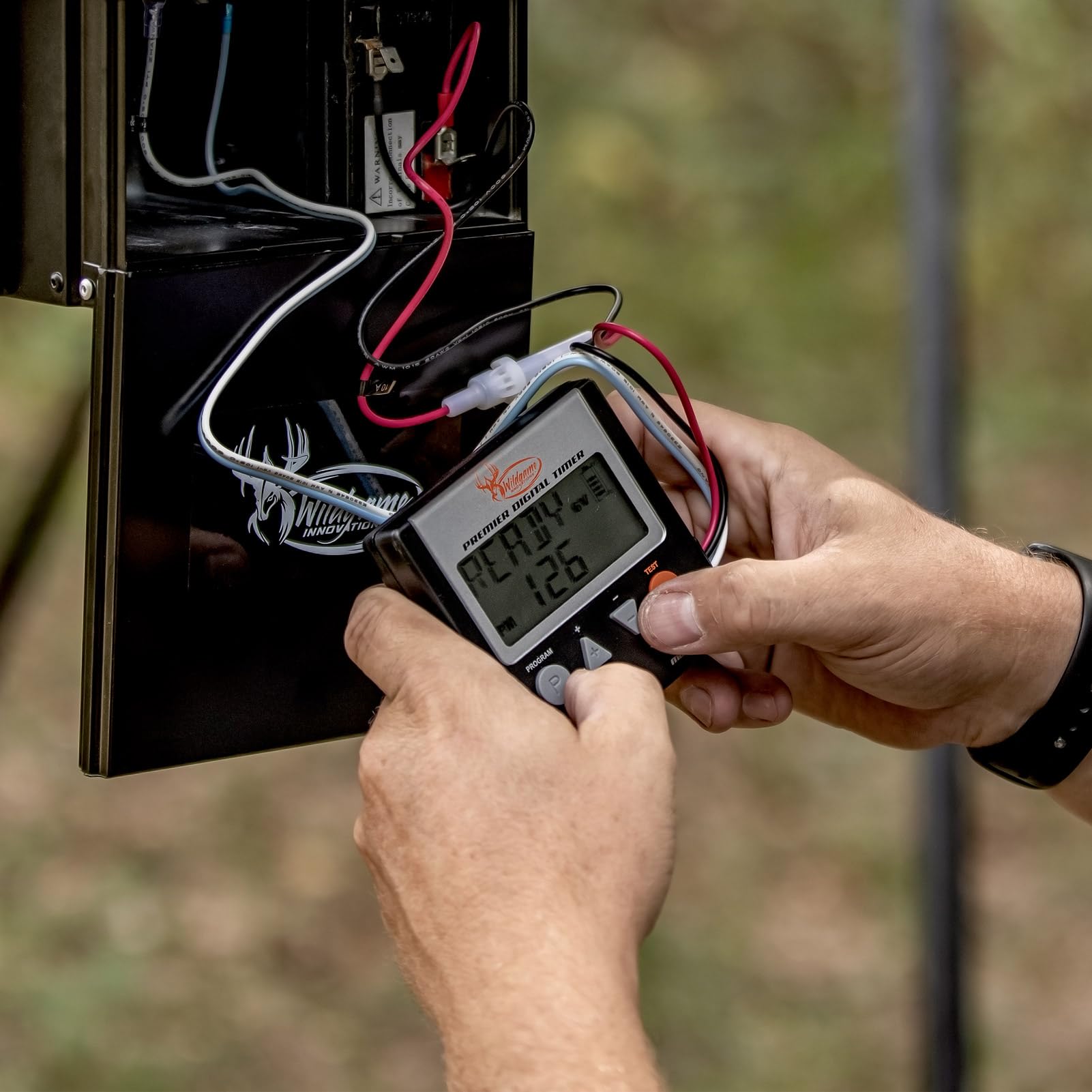 Wildgame Innovations Evolution Feeder installation mount demonstrates sturdy setup for rugged field use