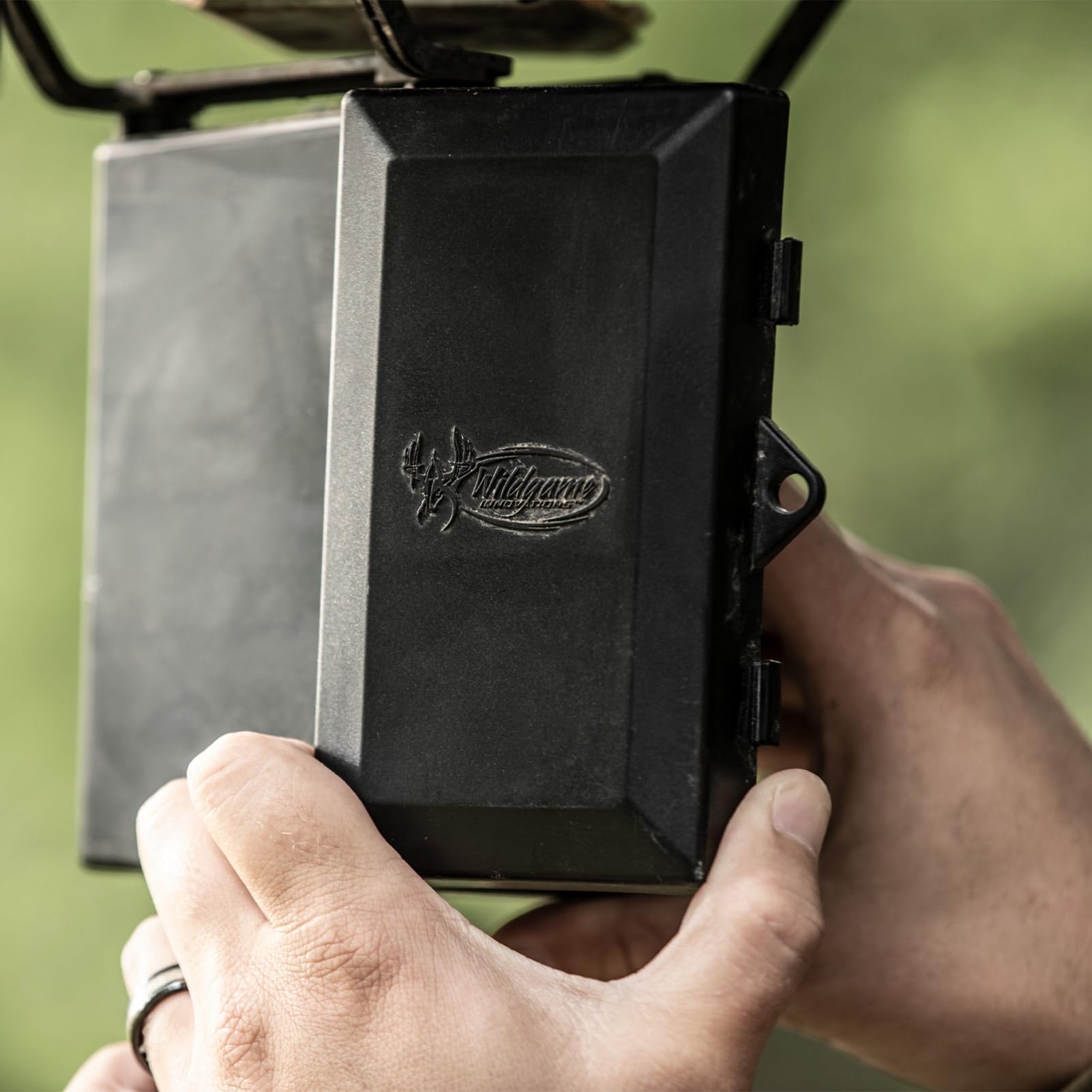 Wildgame Innovations hanging pail feeder in RealTree Xtra camo, portable setup for field spots.