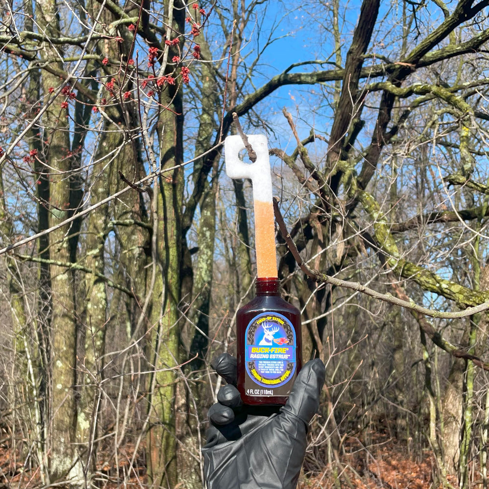 Buck-Fire Raging Estrus pour-spout bottle for easy scent application in field.