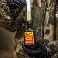 Scent dispersion moment as Estrus Gold is released near a stand.