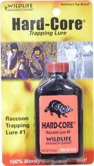 Hard Core Racoon Lure bottle with field/trapping setup