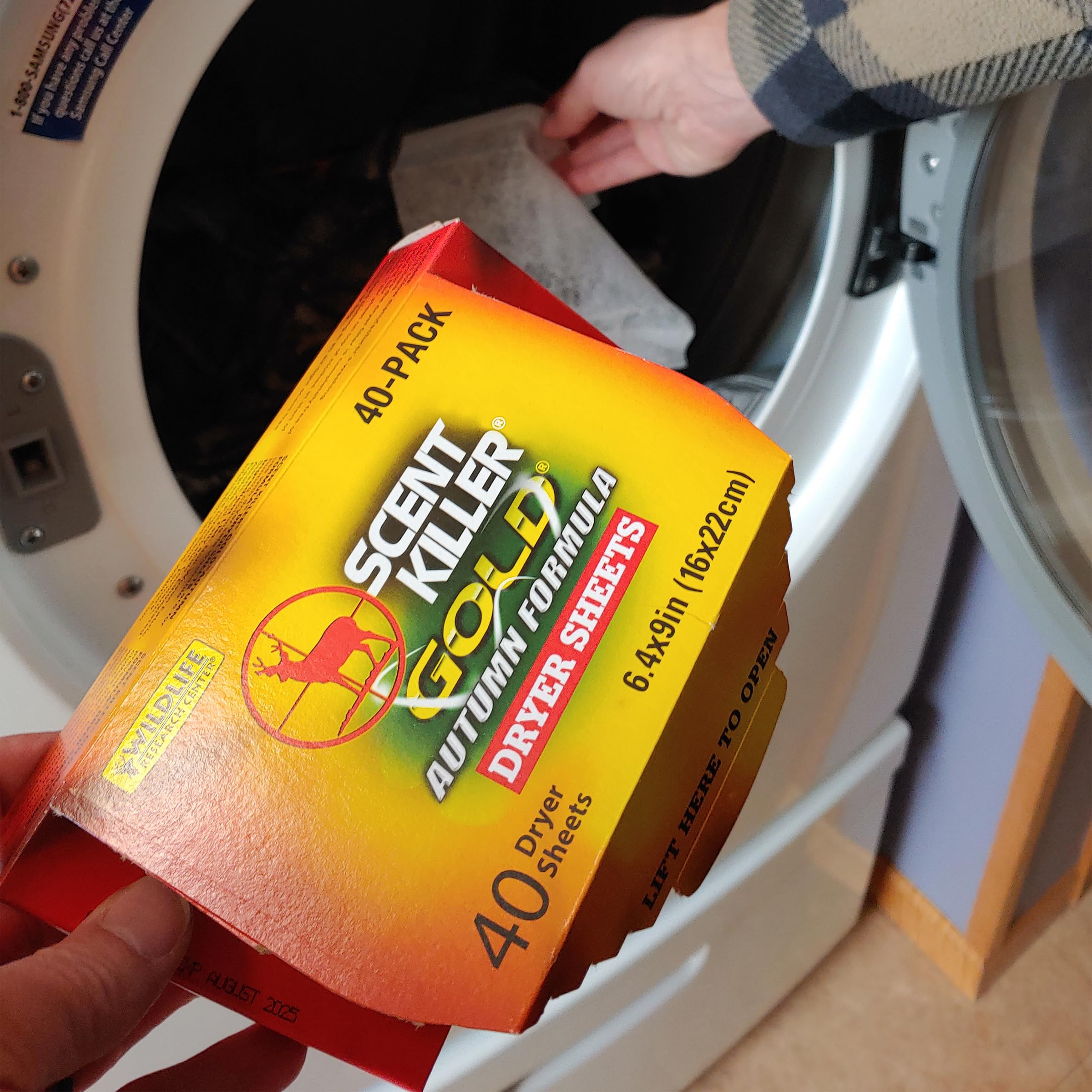 Dryer sheet in dryer with hunting apparel for odor management