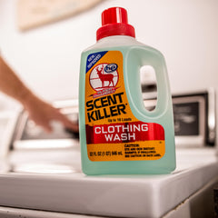 Wildlife Research Center Scent Killer Super Charged Clothing Wash green bottle on gear shelf for field use