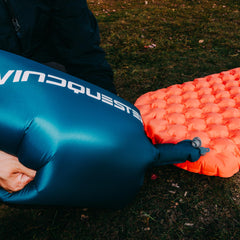 WindQUESTER Elevate X compact-packed pad ready for backpacking, highlighting lightweight design for long treks.