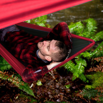 Wise Owl Outfitters 11 by 9 foot coverage over hammock in campsite.