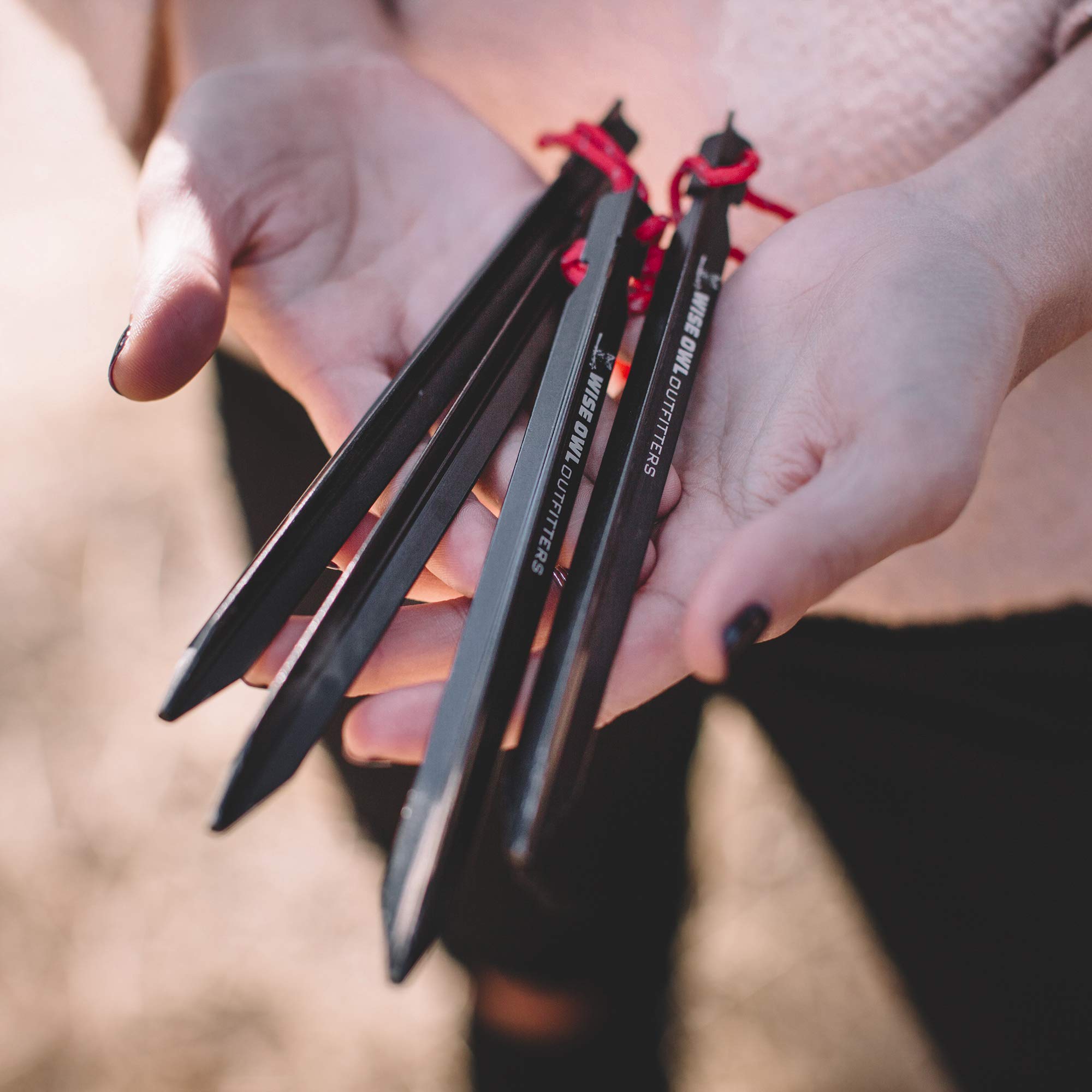Wise Owl Outfitters tent stakes close-up showing 7.25-inch length for secure anchoring.