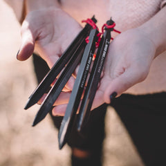 Wise Owl Outfitters tent stakes close-up showing 7.25-inch length for secure anchoring.