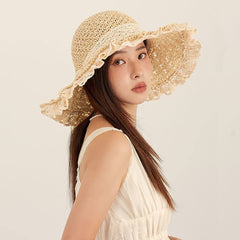 Model wearing beige lace straw hat at the beach