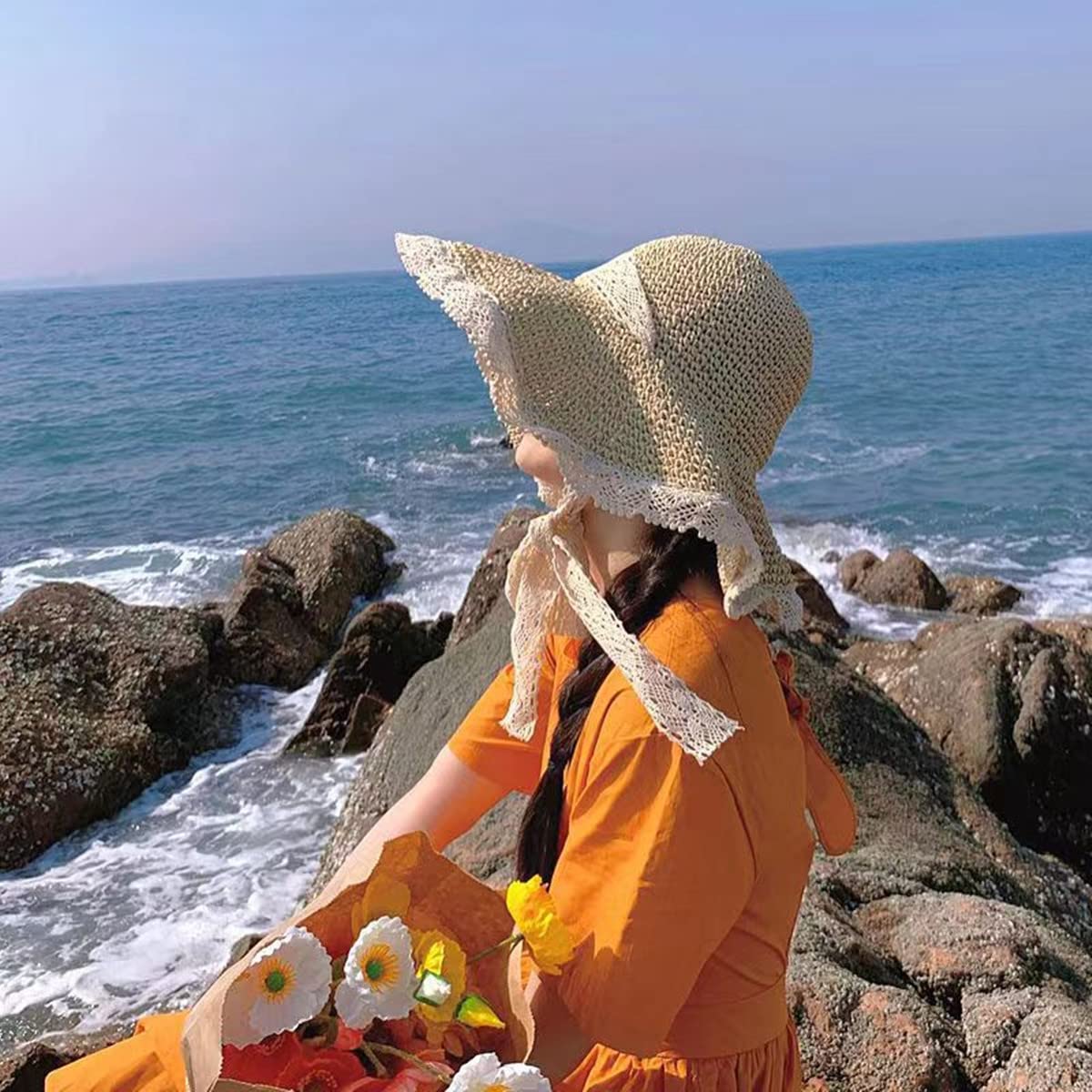 Side view of wide brim lace straw hat with chin strap