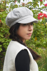 Close-up of 8-panel crown on light gray newsboy hat