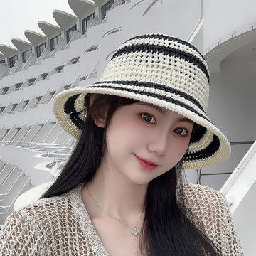 Foldable white striped crochet straw sun hat on model showing wide brim