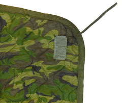 Woodland Poncho Liner folded, compact warmth for camping or emergencies