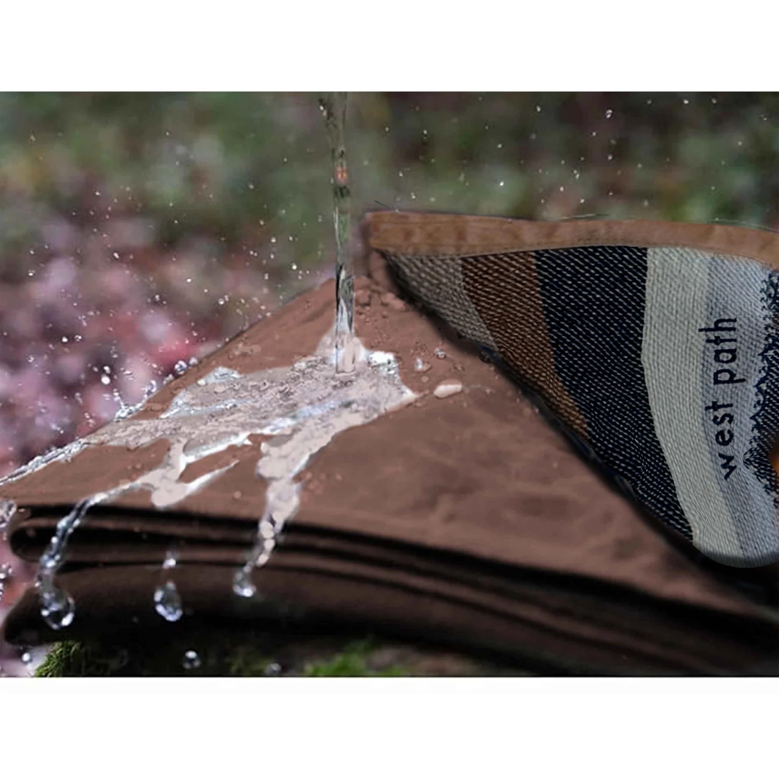 WP West Path Canvas Camp Blanket used as a camping mat on uneven terrain.